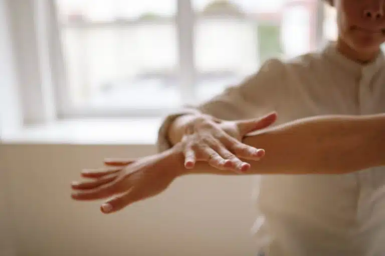 Person focusing on body sensations during somatic therapy for trauma healing