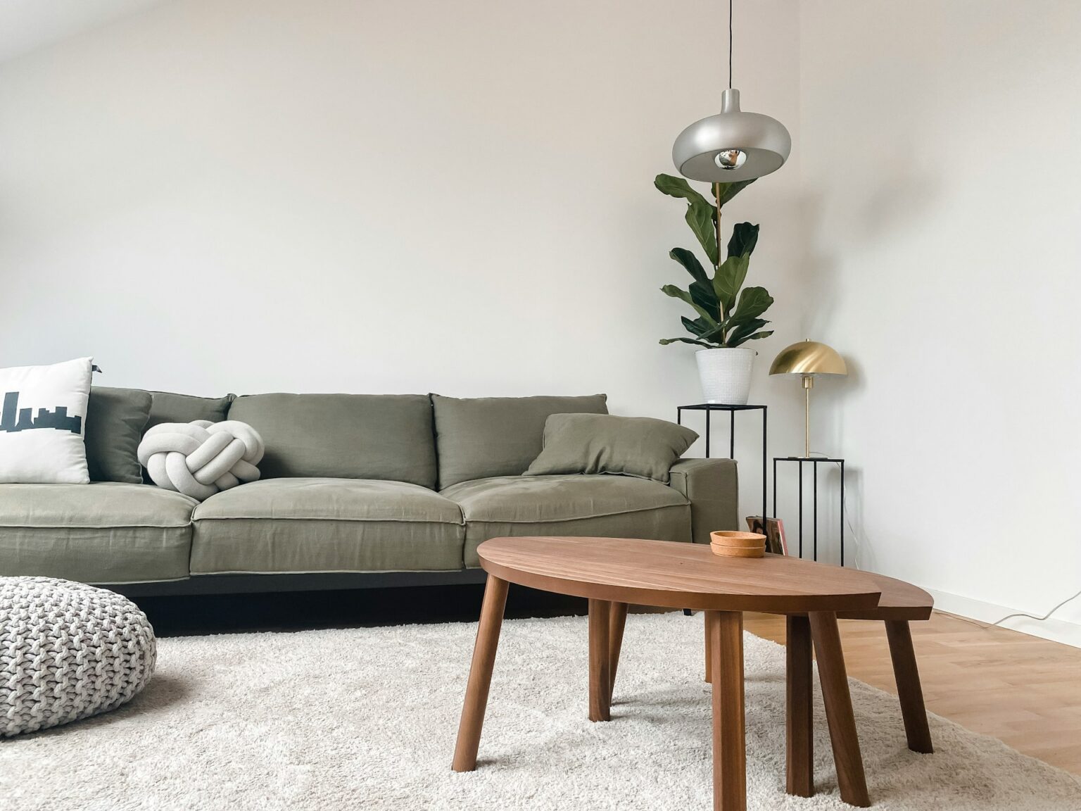 2 seat sofa near brown wooden coffee table