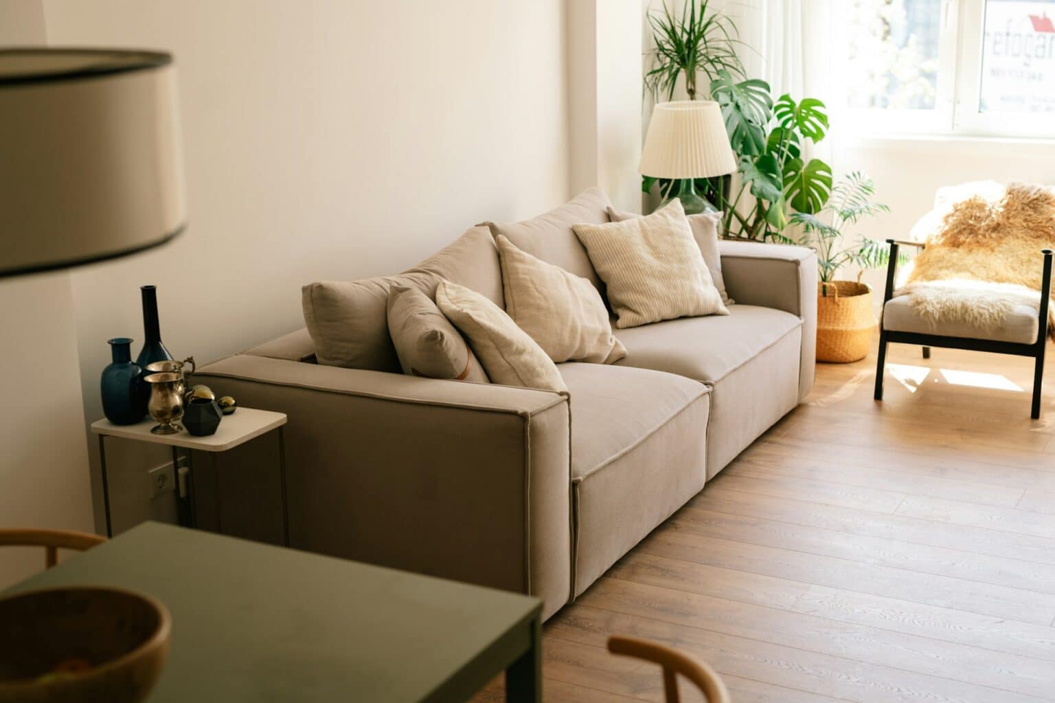 2 seat sofa near brown wooden coffee table