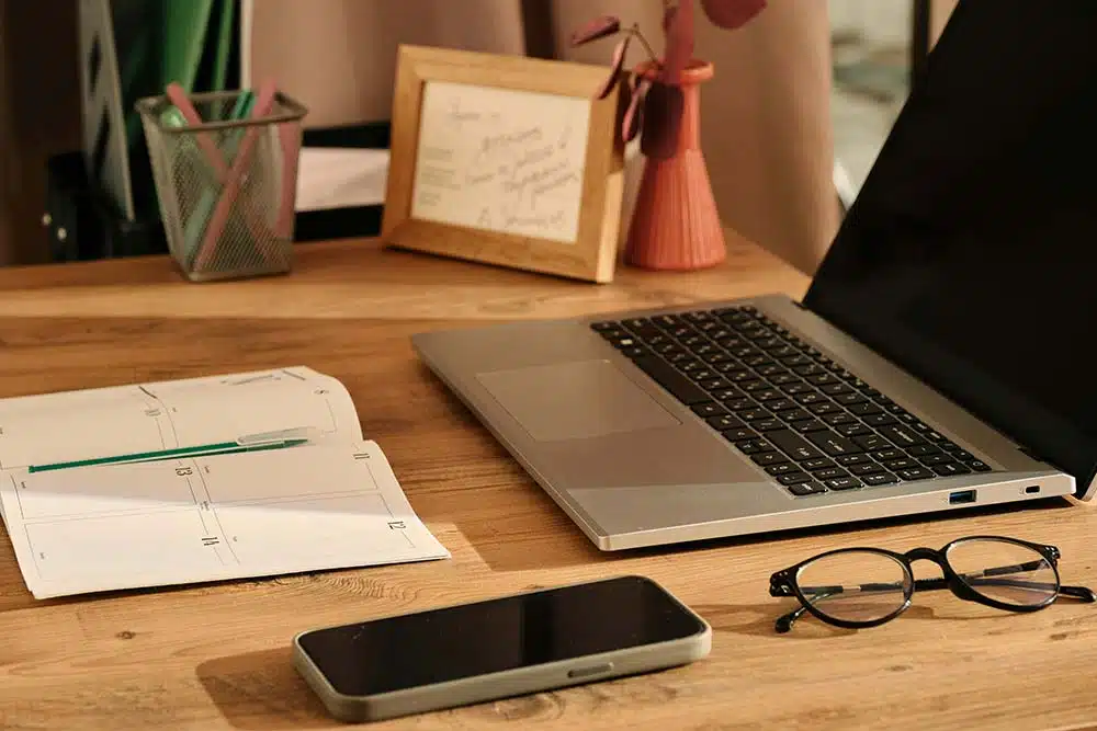 a laptop computer sitting on top of a wooden desk