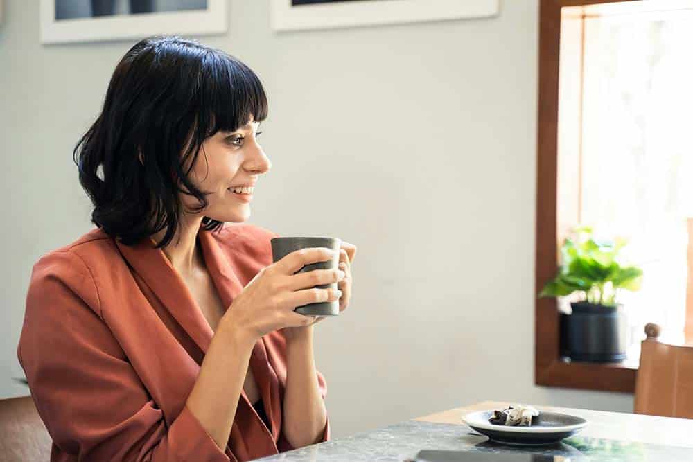 beauty caucasian woman drinking coffee in cafe