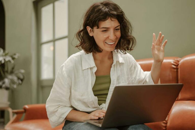 Woman sitting on a couch using a laptop computer