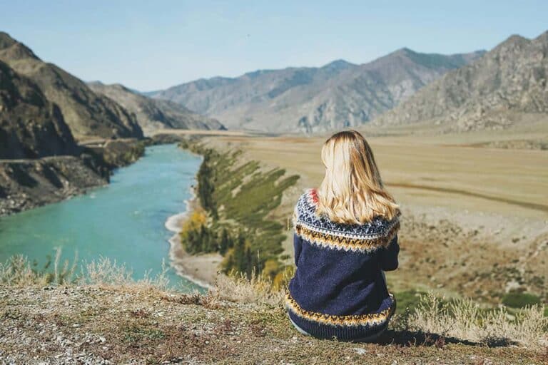 Young blonde woman wearing a Nordic sweater.