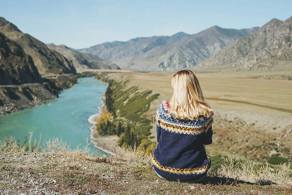 Young blonde woman wearing a Nordic sweater.